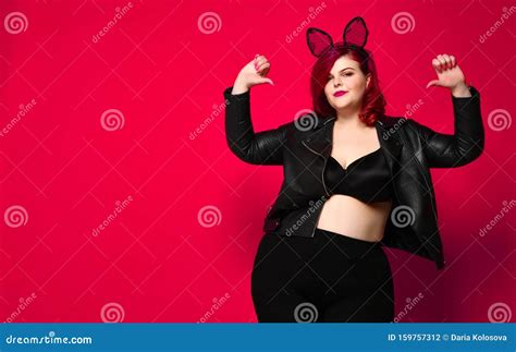 Cute Plus Size Brunette With Black Bunny Ears In Leather Jacket And Underwear Posing On Red
