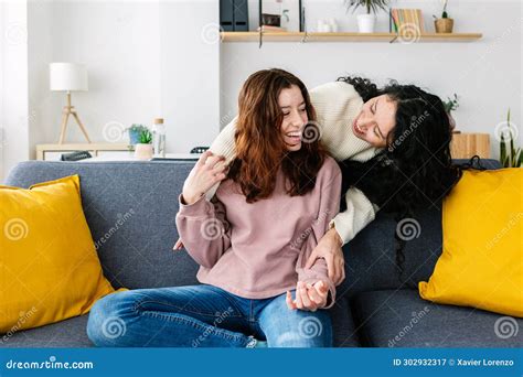 Young Female Friends Having Fun Hugging Each Other At Home Stock Image