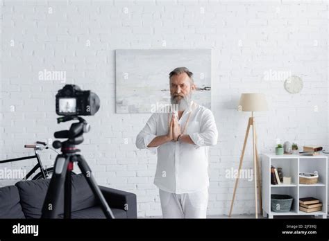 Bearded Master Guru Meditating With Praying Hands In Front Of Digital