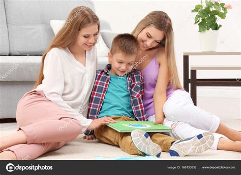 Lesbian Couple Reading With Son Stock Photo By Belchonock 166133832