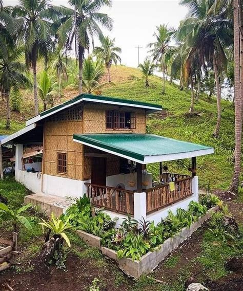 A Small House With A Green Roof Surrounded By Palm Trees