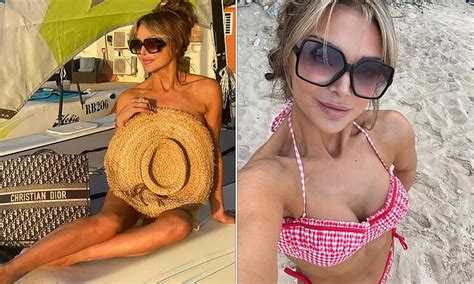 Lizzie Cundy Protects Her Modesty With A Straw Hat While Posing In The Nude As She Enjoys A