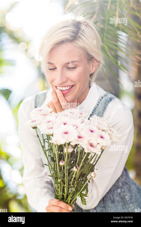 Pretty Blonde Woman Holding Bunch Of Flowers Stock Photo Alamy
