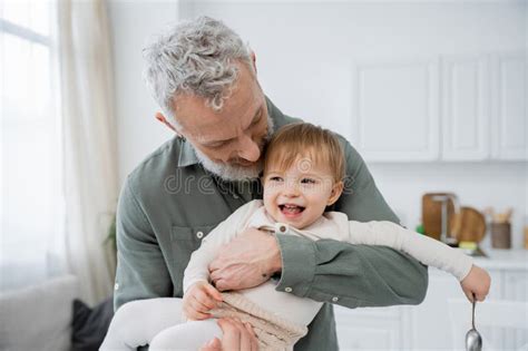 Bearded Mature Man Embracing Carefree Granddaughter Stock Photo Image Of Cheerful Grandfather