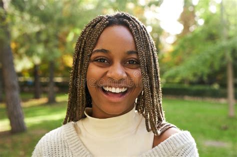 Portrait Of Young Pretty Black Woman Smiling And Looking At Camera