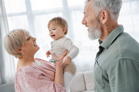 Happy Mature Woman Holding Beloved Granddaughter Stock Image Image Of Emotion Grandma