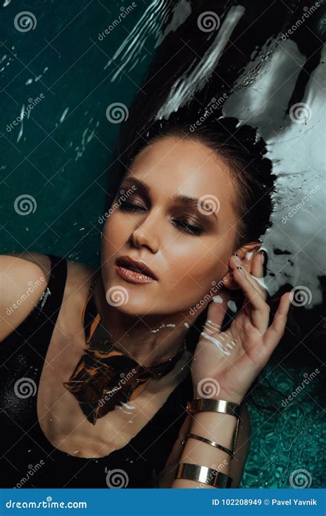 Portrait Of Beautiful Hot Woman Lies On The Water Pool Fingers Touch The Face Sexually Stock