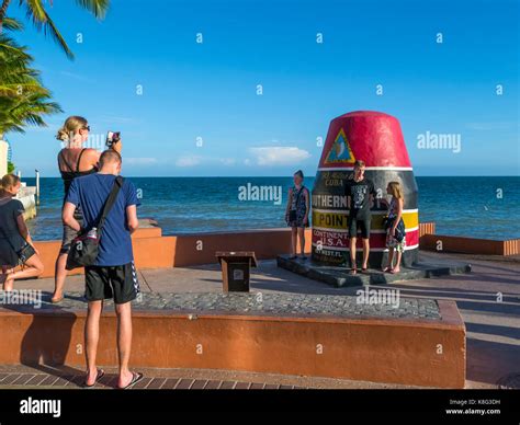 People Taking Pictures At The Southernmost Point Buoy In Key West Florida Is The Southernmost