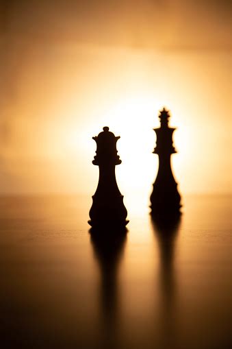 Chess Pieces In Silhouette With King And Queen In Central Position