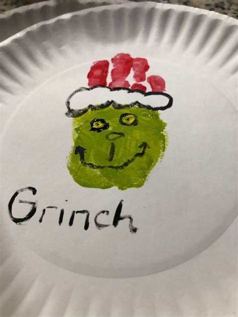a paper plate with the words grin on it and a hand drawn face in red