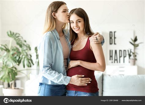 Happy Pregnant Lesbian Couple At Home Stock Photo By Serezniy