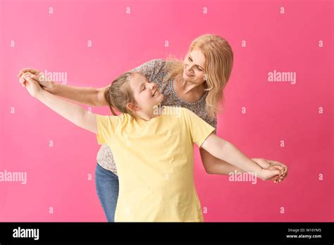 Mature Woman And Her Cute Granddaughter On Color Background Stock Photo Alamy