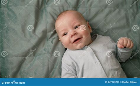 A Cute Naked Newborn Baby Lies On A Blanket A Cute Boy Lies Naked On