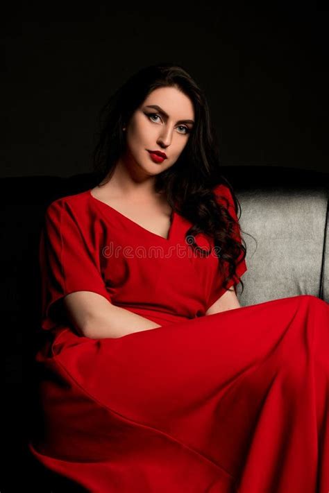 Brunette In Red Sitting On The Sofa Stock Photo Image Of Silver Erotica