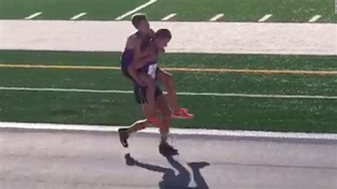 Runner sacrifices race to carry teammate - CNN Video