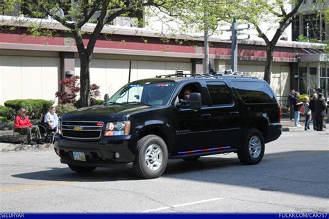 A Black Truck Is Driving Down The Street