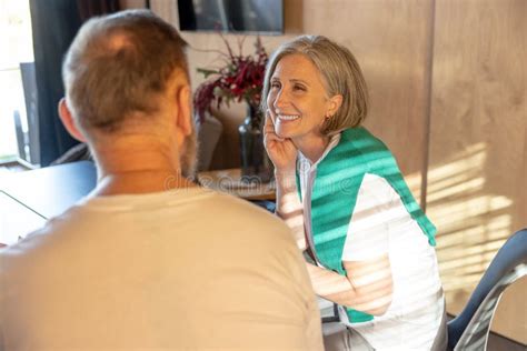 Mature Man And Woman Having Meal Together And Looking Happy And Enjoyed