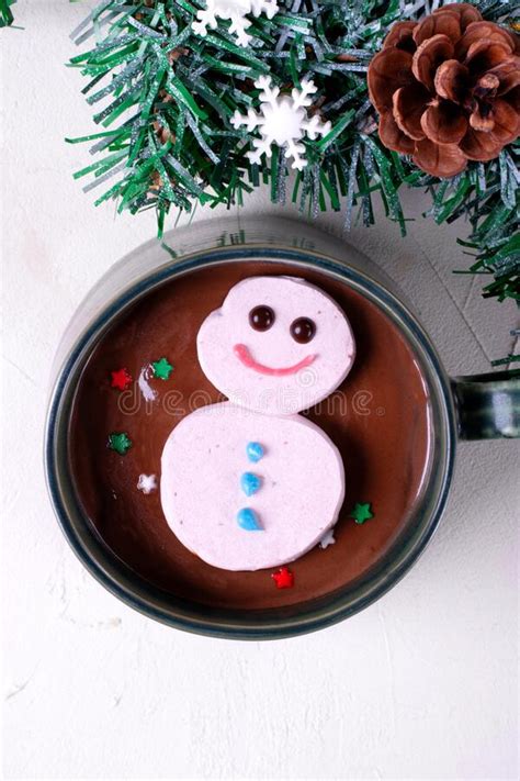 Cute Marshmallow Snowman Floating On Top Of Hot Chocolate Stock Photo