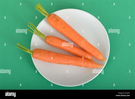 Three Raw Uncooked Carrots Providing 100 Calories Stock Photo Alamy