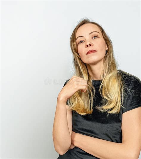 Dreamy Blonde Woman In Black Top On White Background Hand Near Hair Stock Photo Image Of