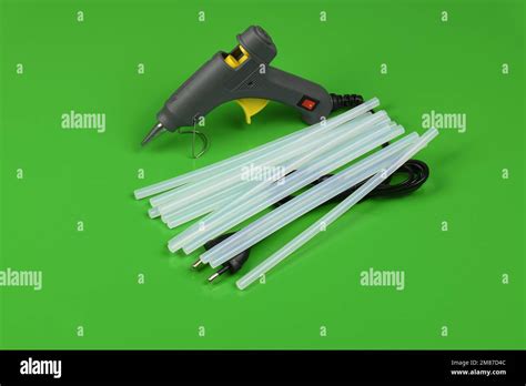 Electric Hot Glue Gun With Gluestick Isolated On Green Background High Resolution Photo Full