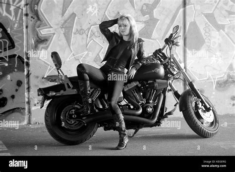 Beautiful Blonde Girl In Black With A Harley Davidson Motorcycle Stock Photo Alamy