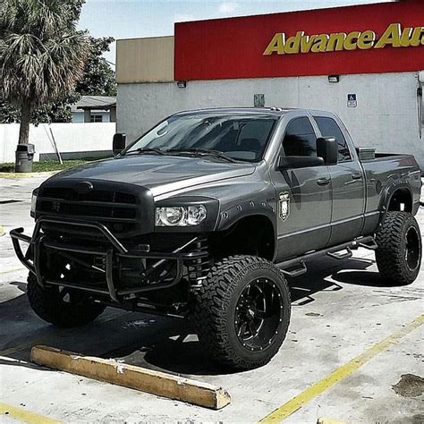 A Gray Truck Parked In Front Of A Advance Auto Store