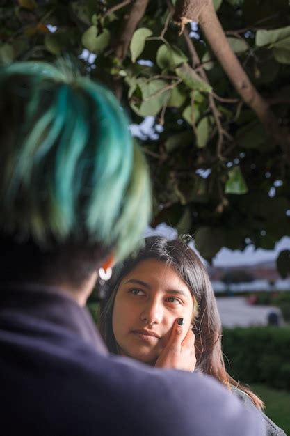 Premium Photo Focus On A Lesbian Woman Caressing The Face Of Her Lover In A Park