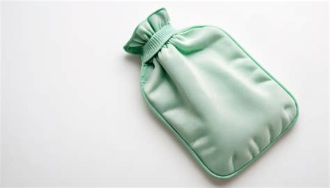 Premium Photo Green Or Mint Hot Water Bottle Or Bag For Relieving Menstrual Pain With Copy Space