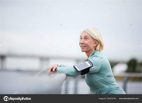 Mature Serene Sportswoman Blonde Hair Enjoying Solitude While Standing Front Stock Photo