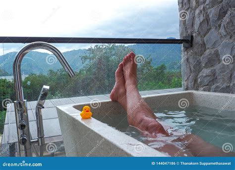 A Man Is Enjoying A Dip In The Hot Tub With Mountain Front Stock Photo Image Of Female Flow
