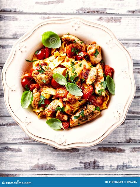 Tagliatelle Pasta with Grilled Chicken Fillet and Cherry Tomatoes Stock ...