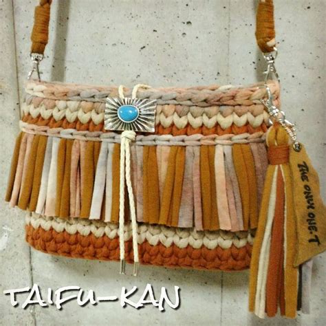 A Purse With Tassels Hanging From It S Side