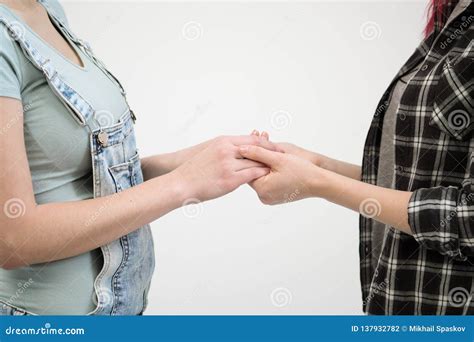 Two Girls In Jeans Hold Hands Close Up White Background Homosexual Lesbian Couple Stock Photo
