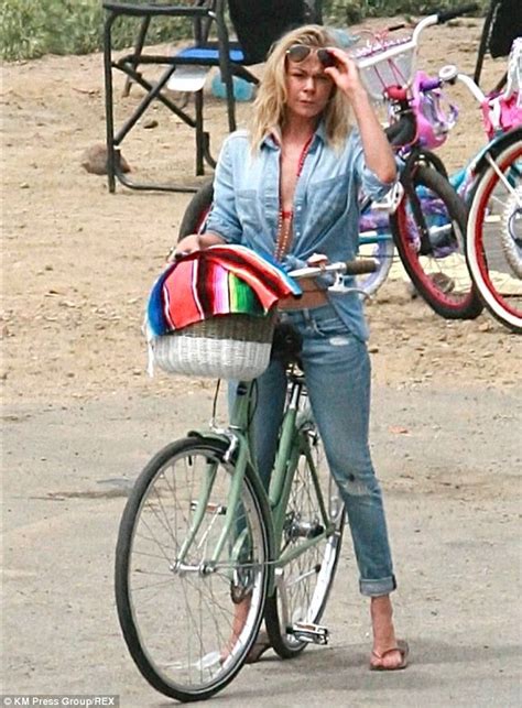 LeAnn Rimes Reveals Toned Stomach And Red Bikini In Unbuttoned Shirt As She Rides Her Bike On
