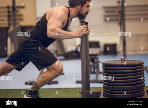 Sled Push Man Pushing Weights Workout Exercise At Gym Stock Photo Alamy
