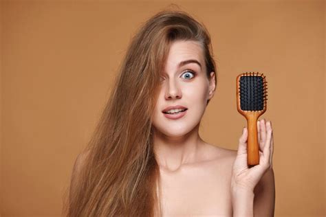 Premium Photo Beautiful Smiling Brunette Woman Showing Wooden Brush