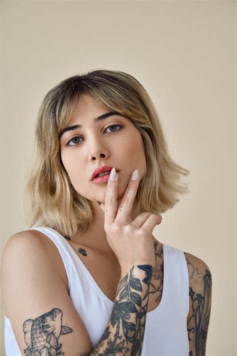 Cool Blonde Gen Z Girl Pretty Face And Tattoos At Beige Background Portrait Stock Photo