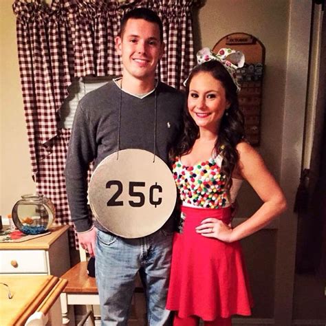 a man and woman standing next to each other in front of a table with a ...