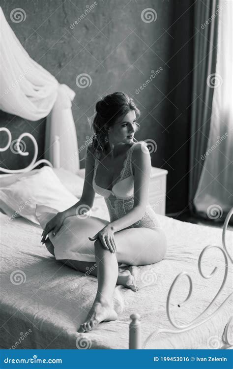 Beautiful Bride In White Lingerie Lying On The Bed In Her Bedroom Stock Photo Image Of