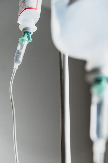 Premium Photo Close Up Of Iv Saline Solution Drip For Patient In Hospital