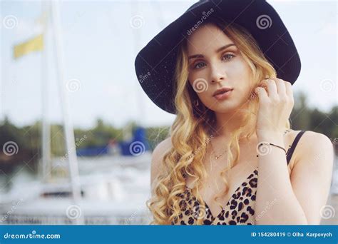 Girls On Background Of Yachts Sailing Boats Smiling Looking At The Camera Beautiful Blonde Is
