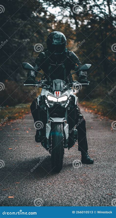 Vertical Shot Of A Person On A Kawasaki Z900 Naked Motorbike In The Forest Editorial Stock Photo