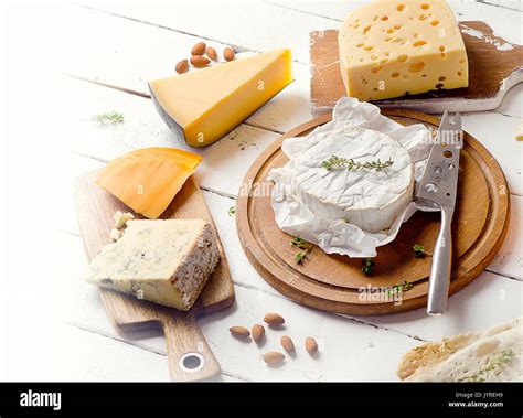 Different kinds of cheeses on white background Stock Photo - Alamy