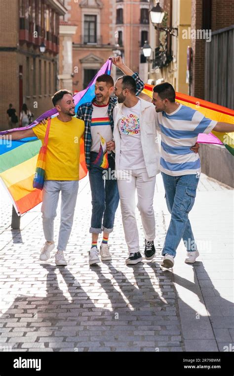 Radiant Friendship Four Gay Men Embrace Smile And Flaunt LGBT Pride