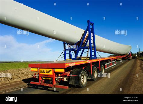 Giant blades for a wind turbine being transported by road in South ...