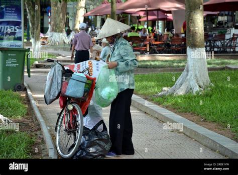 A Woman Who Wears A Traditional Conical Hat Or Non La Or Palm Leaf