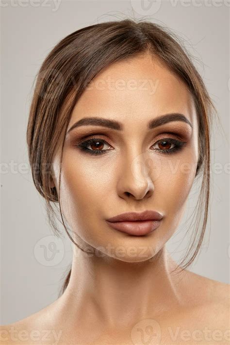 Close Up Portrait Of A Brunette Nude Model Girl With Professional Evening Make Up And Plump Lips