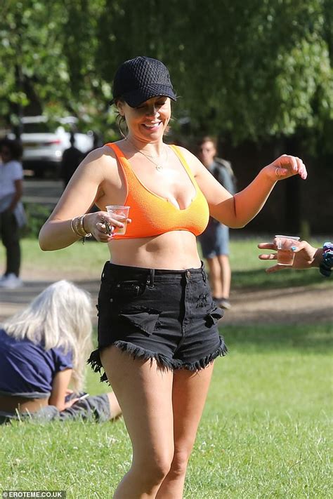 Imogen Thomas Showcases Her Curves In An Orange Bikini And Black Hot Pants As She Sips On Ros