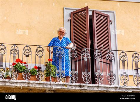 elderly lady     street   balcony